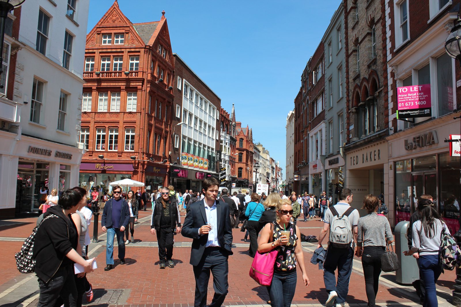 People walking along Grafton Street on a sunny day
